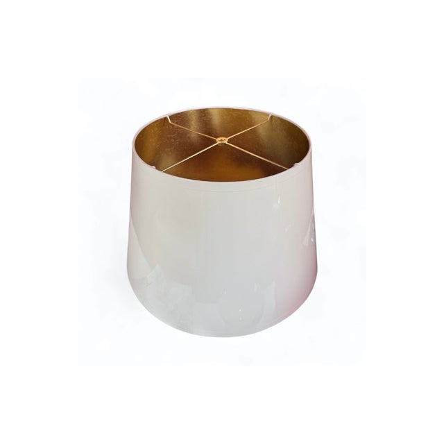 This custom hand-lacquered lampshade features a high-gloss hardback exterior and a gold ponyhair-lined interior that casts...