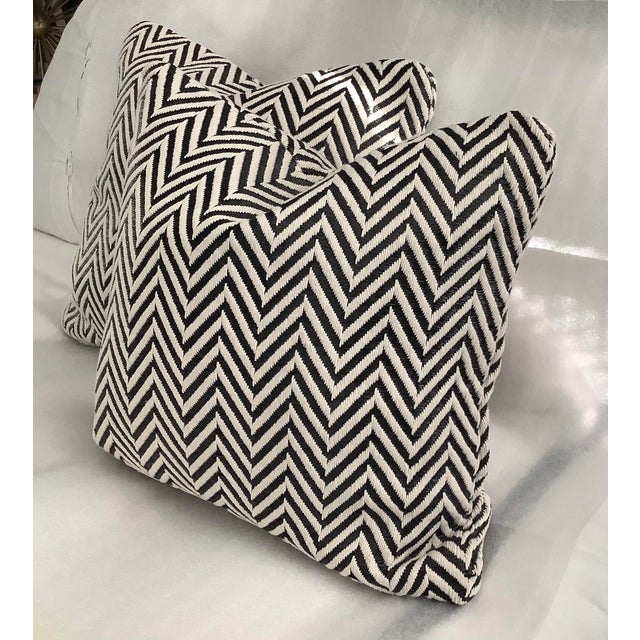 This product is a set of two black and white herringbone jacquard decorative pillow covers, measuring 18 inches in size....