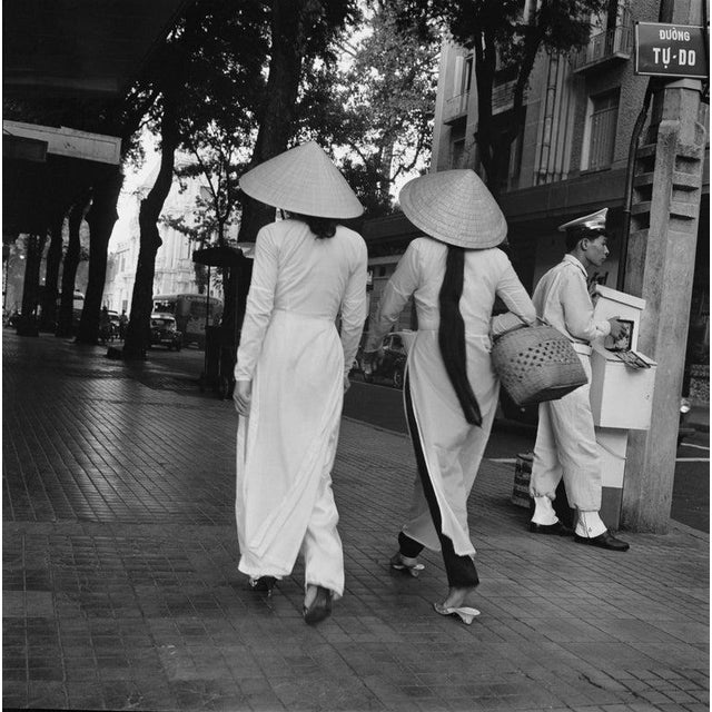 Women In Saigon Two women in straw hats on a Duong Tu-Do, later Duong Dong Khoi in Saigon (later Ho Chi Minh City),...
