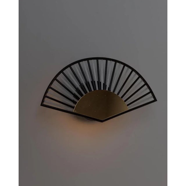 This vintage wall lamp from the 1980s is a stunning example of hollywood regency style, combining artistry and elegance....