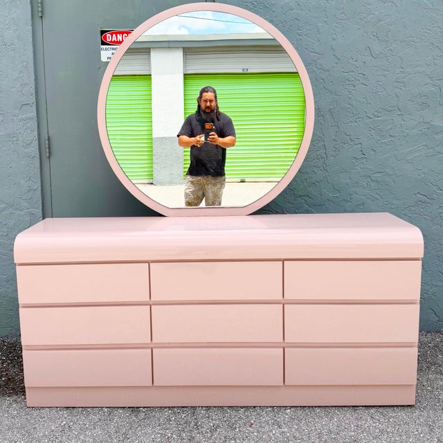 A fabulous vintage Postmodern dresser featuring a soft pink gloss laminate finish and signature waterfall styling. The...