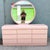 A fabulous vintage Postmodern dresser featuring a soft pink gloss laminate finish and signature waterfall styling. The...