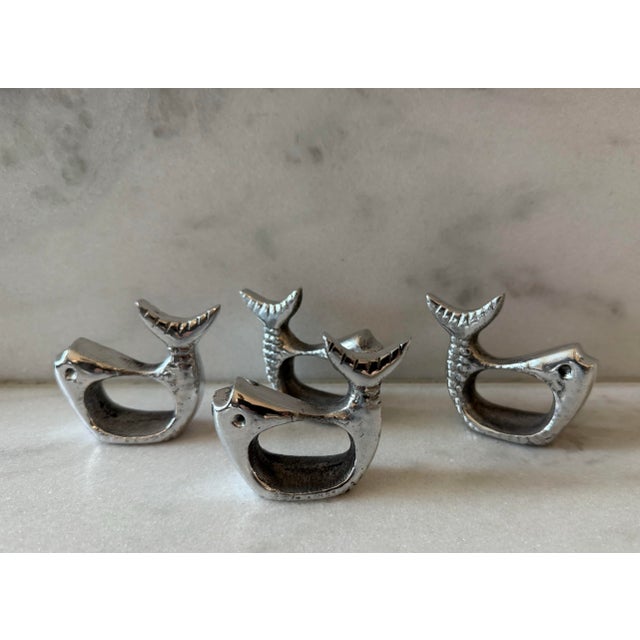 Set of 4 pewter silver napkin rings in the shape of a fish.