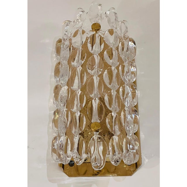A pair luxurious 1950s thick crystal bubble wall lights designed by Carl Fagerland for Orrefors. Rewired with silage brass...