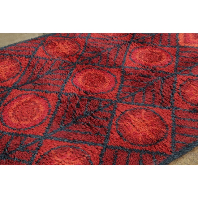 This 6x8 vintage Swedish wool rug, dating to circa 1950–1959, reflects the bold geometric vocabulary and rich textural...