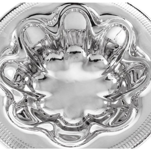 This bowl has an Art Deco style to it; the symmetrical cut-outs along the edge. On the inside eight indented shapes give...