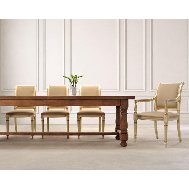 An elegant suite of eight French dining chairs crafted in the grand Louis XVI style, consisting of six side chairs and two...