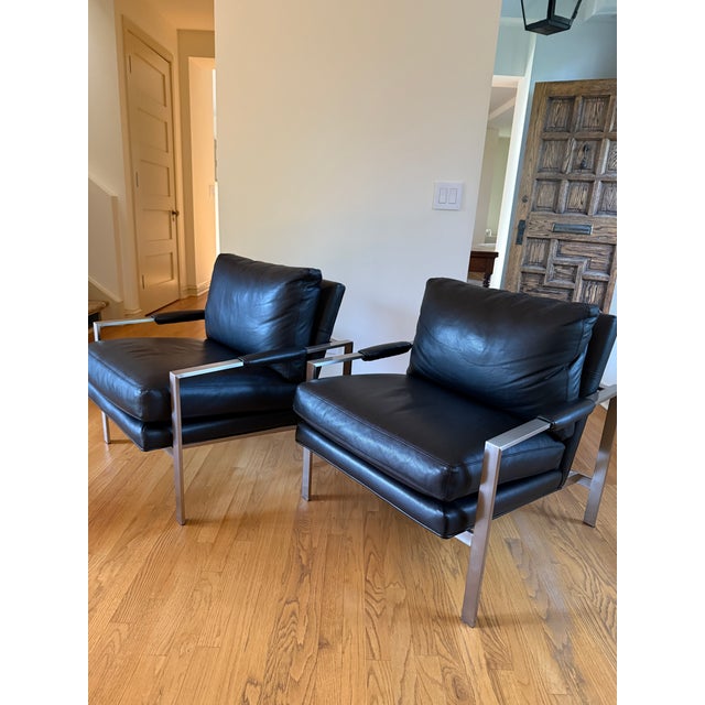 These stylish black full-grain leather lounge armchairs are by Milo Baughman for Thayer Coggin, originally designed in...