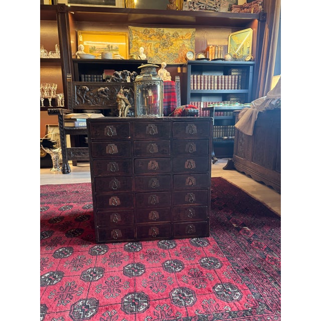 A beautifully preserved antique Chinese apothecary cabinet, originally used in traditional medicine practices to store and...