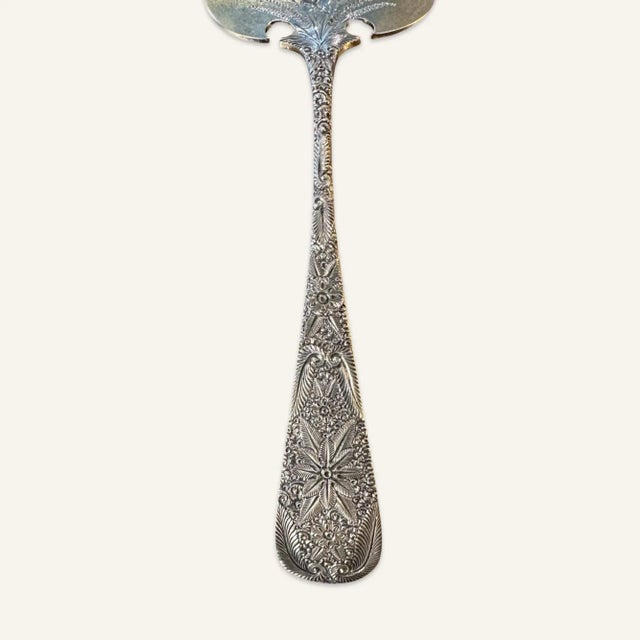 19th century sterling silver asparagus fork by J. E. Caldwell & Company with etched floral and leaf decoration. This...