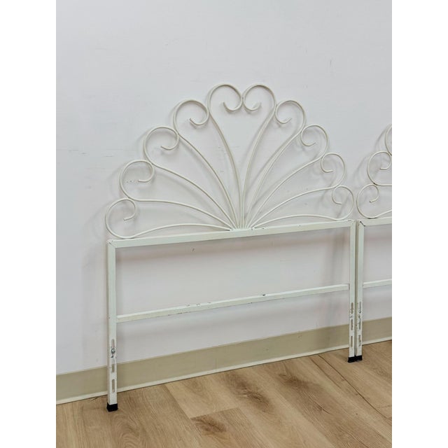 This pair of vintage wrought iron twin headboards brings a charming French country sensibility to any bedroom, finished in...