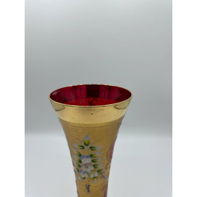 Great Cranberry blown glass vase with hand applied gilt and floral decoration! Center cartouche flowers are pansies, and...