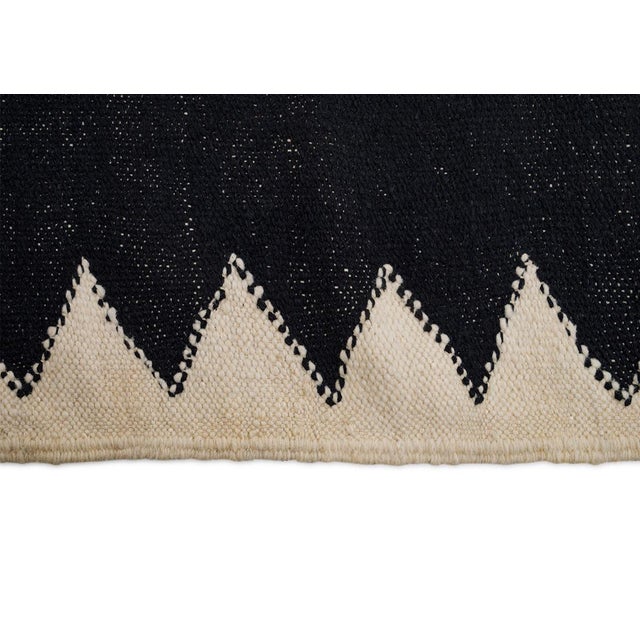 Bold flatweave rug featuring a deep Charcoal center framed by zigzag Ivory edges. Its minimalist design and striking...