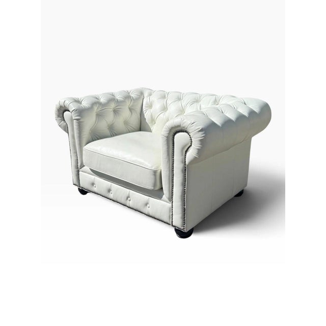 A beautiful white leather Chesterfield club chair, wide enough at 54 inches to read as a chair-and-a-half. Deep button...