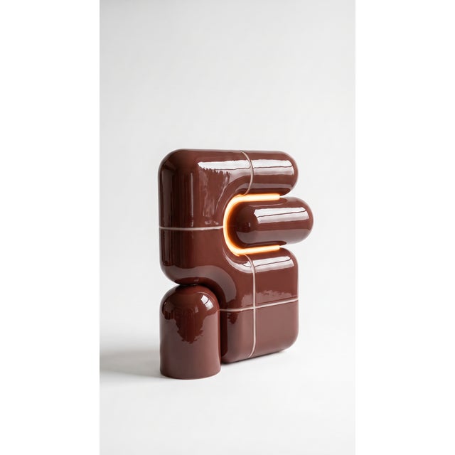 The smallest lamp in the collection, and often the first one people reach for. Its folded form hides the source entirely,...