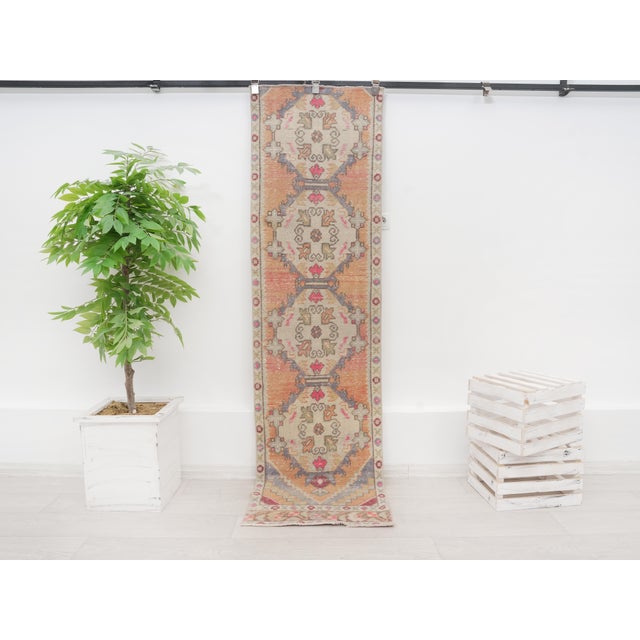 Add timeless Anatolian charm and warmth to your home with this exquisite vintage Turkish runner rug. Hand-knotted from...