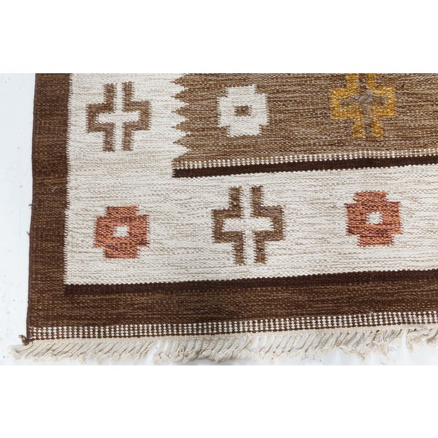 Vintage Scandinavian Flat-Weave Rug in Earth Tones Size: 4'6" × 6'6" (137 × 198 cm) This vintage Scandinavian rug from the...