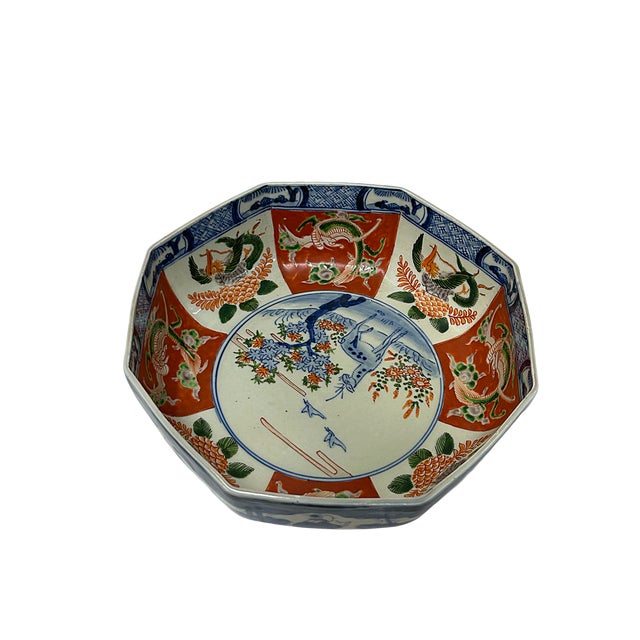 An exquisite and heavily potted Japanese Imari porcelain octagonal bowl, featuring a brilliant palette of vibrant iron-...