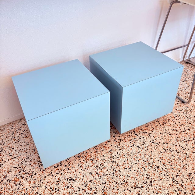 A striking pair of 1980s laminate cube side tables with a clean, architectural presence. Finished in a soft powder-blue...