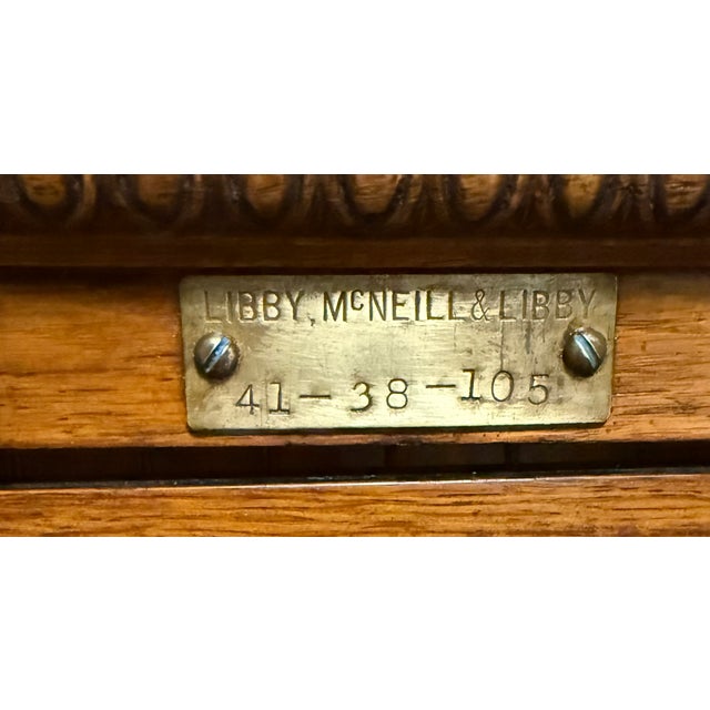 Early 20th-century glass-front wooden display cabinet manufactured by Libby, McNeill & Libby. This is a unique piece of...