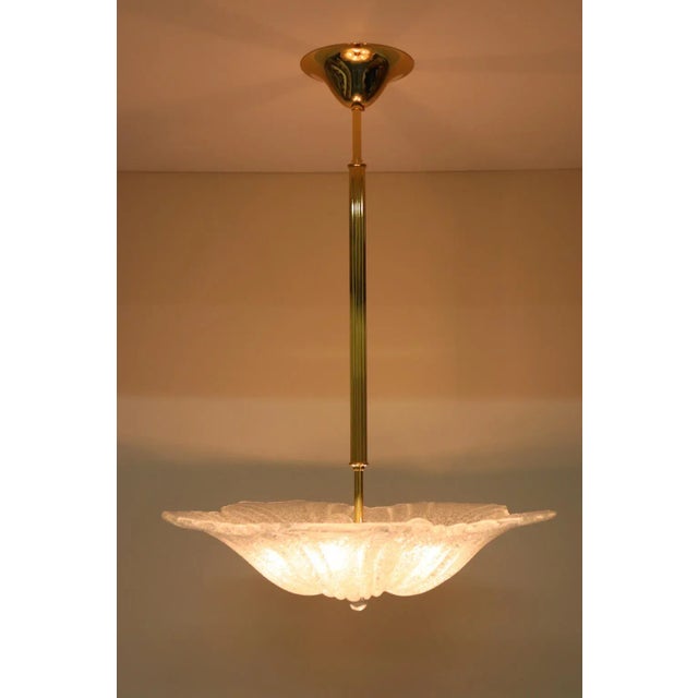 Murano Pendant Light, Cast Glass Hand Finished in Crystal-"Graniglia". Mounting in golden metal. ART648-55 was designed by...