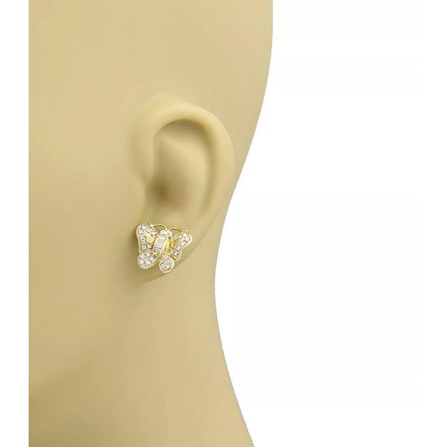 This cute pair of earrings are crafted from solid 18k yellow gold with a polished finish and features butterfly studs, the...