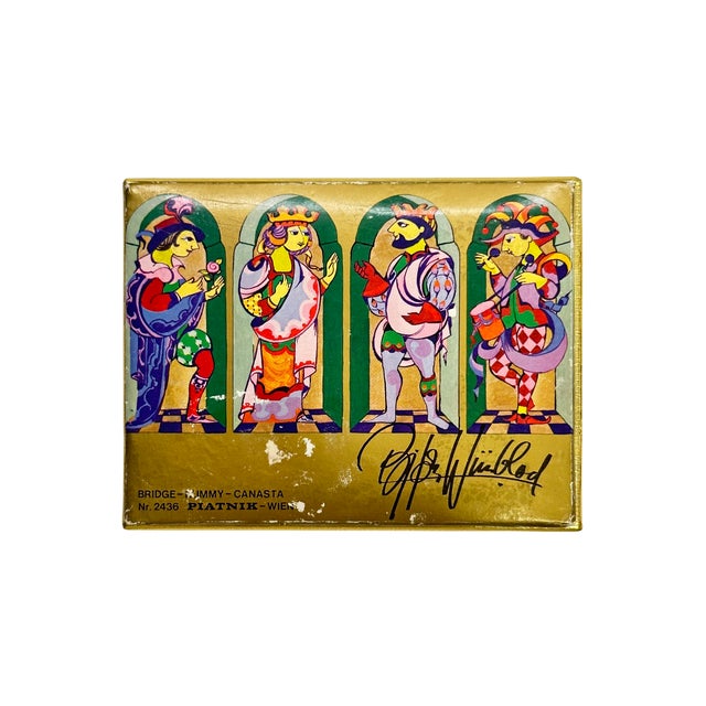 A highly decorative vintage Piatnik playing card set featuring artwork by Jimmy Canasta, presented in its original gold-...