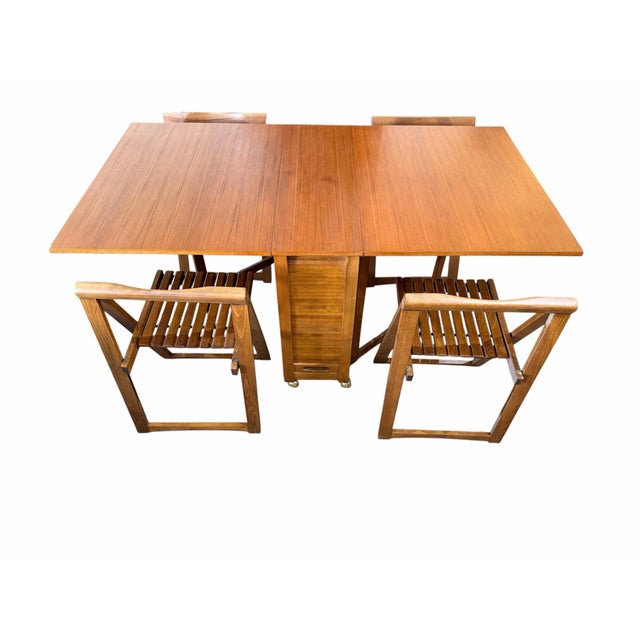 Brilliant Eastern Bloc mid-century engineering. This authentic 1960s "hideaway" dining set was craftsman-built in Romania....