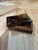 A classic rectangular box finished in a rich faux tortoiseshell lacquer, showcasing a mottled pattern of amber, honey, and...