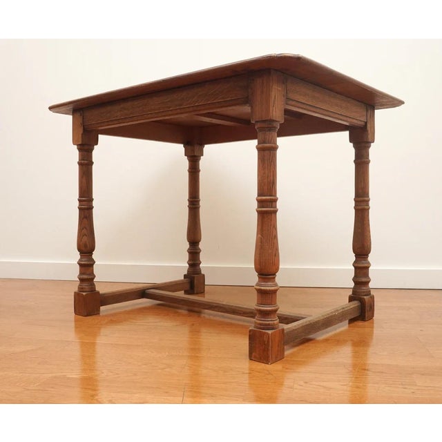 Beautiful wooden table with carved out corner details , turned legs and a low cross stretcher. Wonderful addition to any...