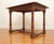 Beautiful wooden table with carved out corner details , turned legs and a low cross stretcher. Wonderful addition to any...