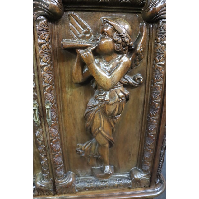 Italian Style Figural Carved 2-door Bar/China Cabinet, top with two doors with carved cherubs one playing the flute and...
