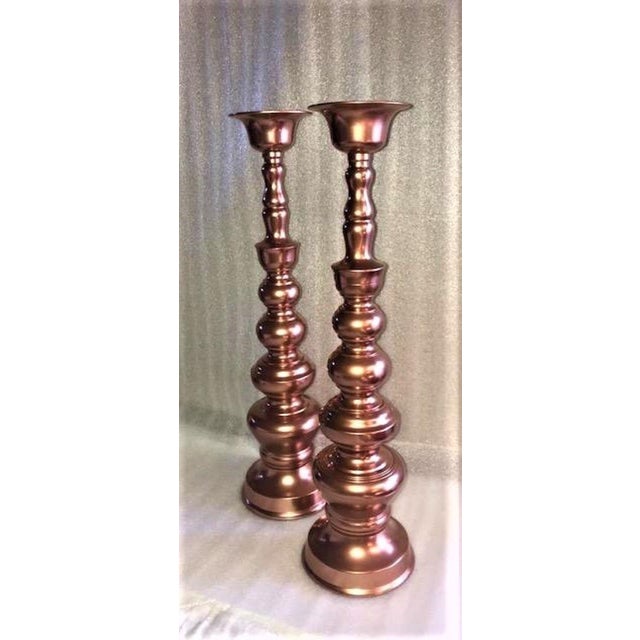 Brass candle sticks painted metallic copper. 4 3/4"dia. at base, 3 1/2"dia. at top, 18"H. Inset dia. for candle stick is...