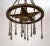 A grand, rustic chandelier with shower hanging lights structured with a downward-facing metal star in a ring with...