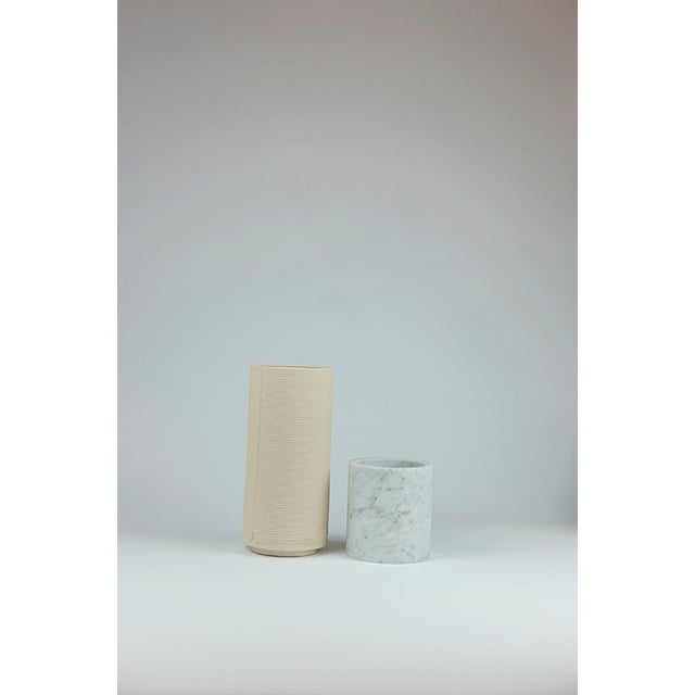 Strand after strand, the clay stratifies like a memory deposited over time. Marble holds the silent weight of ages, of...
