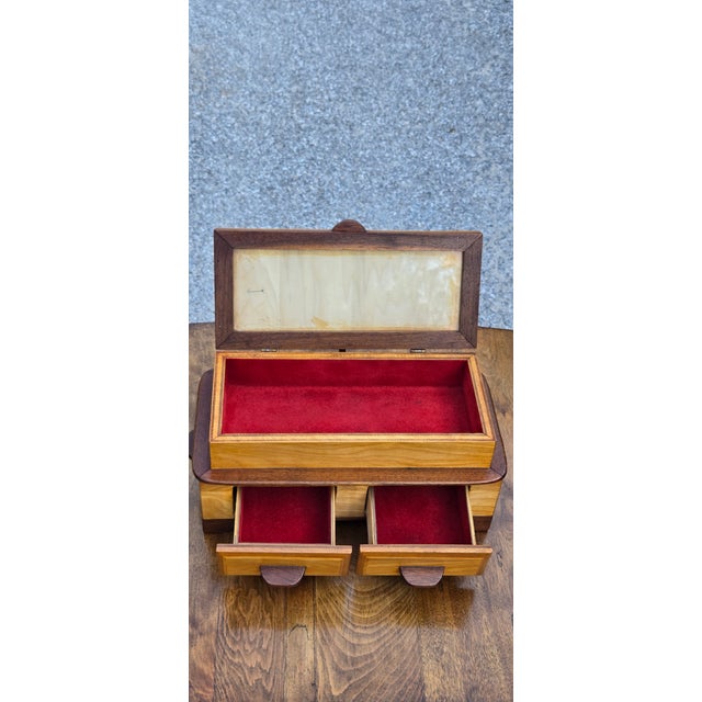 Bring timeless craftsmanship to your home with this beautiful vintage walnut jewelry box featuring a glass display lid,...