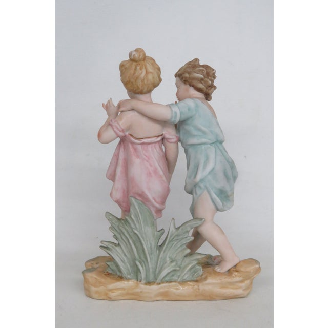 This beautiful Figurine is made out of porcelain. This lovely decorative piece features two figures, a young boy and young...