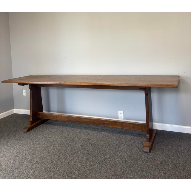 There are tables that furnish a room, and there are tables that become the heart of it. This 19th century English oak...