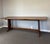 There are tables that furnish a room, and there are tables that become the heart of it. This 19th century English oak...