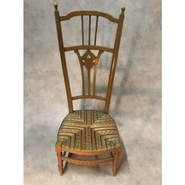 Provencal beech nurse chair, seating in colorful straw.