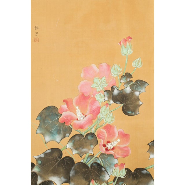 This elegant Meiji-period Japanese two-panel screen depicts graceful hibiscus blossoms in full bloom, their vibrant pink...