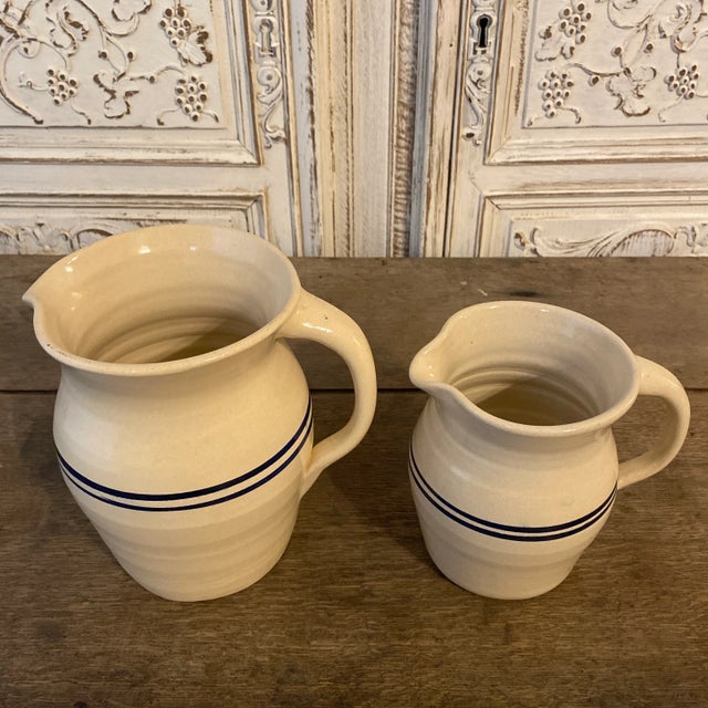 Offered here is a matching pair of Marshall Pottery stoneware pitchers made by the Marshall Pottery Company in Marshall,...
