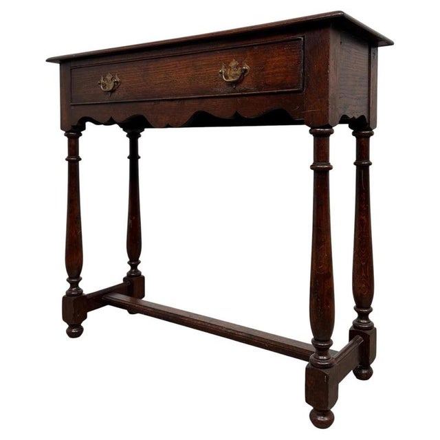 A beautifully proportioned and highly versatile 20th-century narrow side table, crafted in oak and combining traditional...