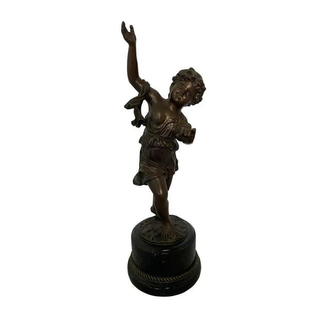 A bronze, whimsically musical-themed cherub statue with marble base. The dancing cherub base has a detailed ground carving...