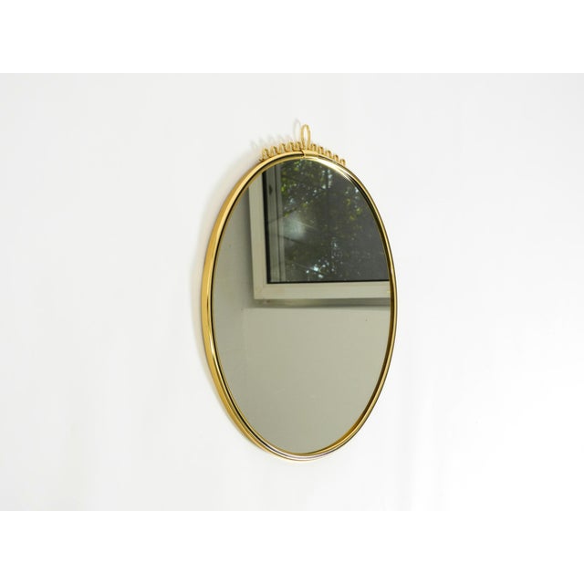 Beautiful, heavy, round Mid-Century Modern brass wall mirror. Manufacturer: Lenz. Made in Germany. Finish: Lenzgold....