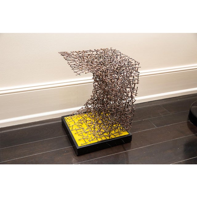 The Nail Side Table by Sven Herman Paditz is a sculptural piece that combines elegance with a bold design. It features a...