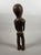 NYAMWEZI, TANZANIA Carved from hardwood with a brown patina and inlaid with bronze rings around the eyes and nipples. This...