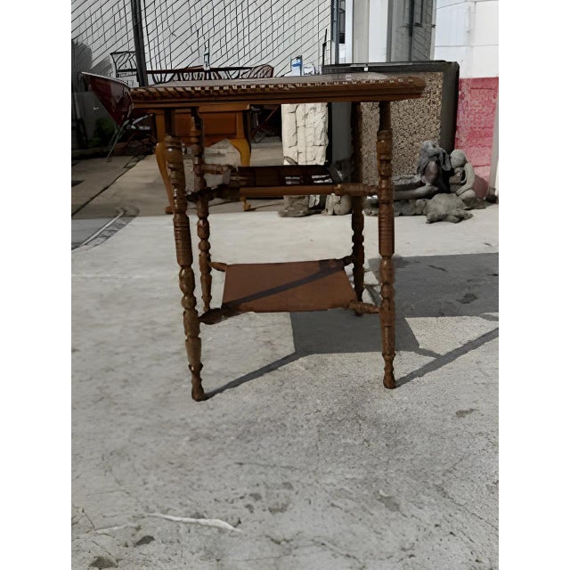 Vintage Aesthetic Movement square turned leg table. It has 3 tiers, the upper one being of nicely crafted fretwork. The...