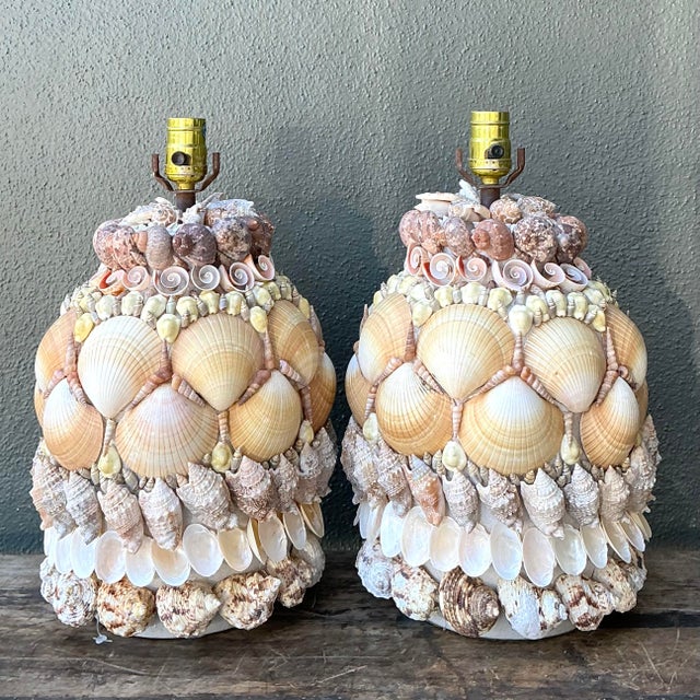 Add a touch of oceanic opulence to your interior with this stunning pair of vintage shell-encrusted table lamps. Inspired...
