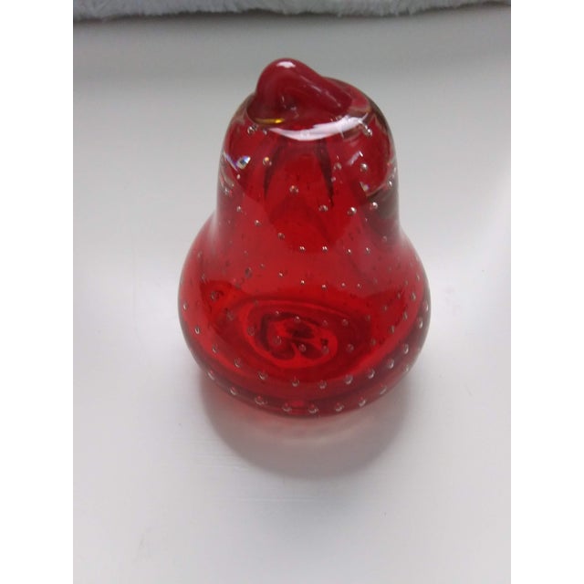 This gorgeous red hand blown glass pear features controlled bubbles throughout. Stand 3.5" tall and 2.5" wide. It is...